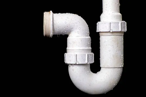 Photo of Hydraulic wet siphon for a wash basin. Accessories and spare parts for plumbers who renovate water and sewage systems. Black background.