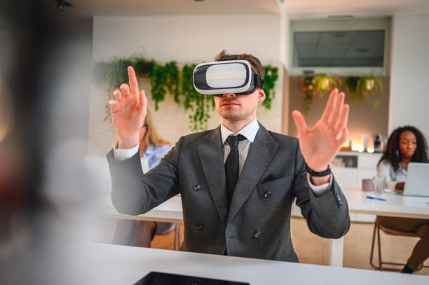 istock Businessman with Virtual Reality Simulator Having Online Meeting in Office 1301284818