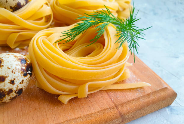 raw pasta,  egg on a concrete background