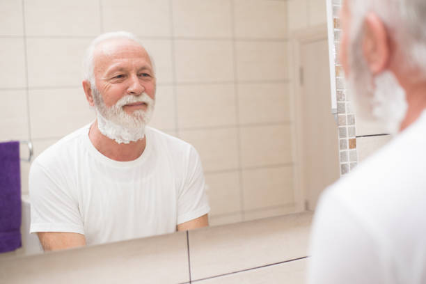 istock Senior man shaving beard in the bathroom 1301287333