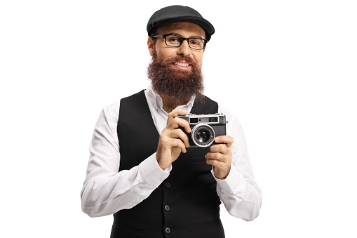 Bearded man hipster with a vintage camera isolated on white background