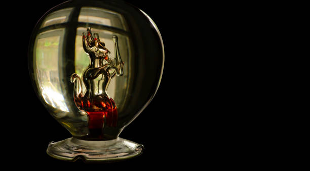 istock A bottle with a glass figure of a devil with red elements inside. Halloween festival concept. Black background with place for text 1301287438