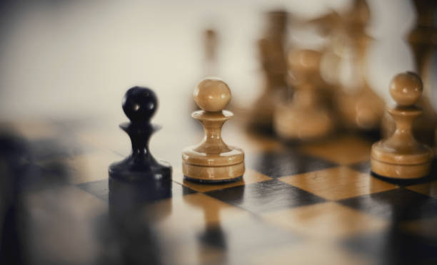 istock Two chess pieces are pawns: black and white. 1301289339