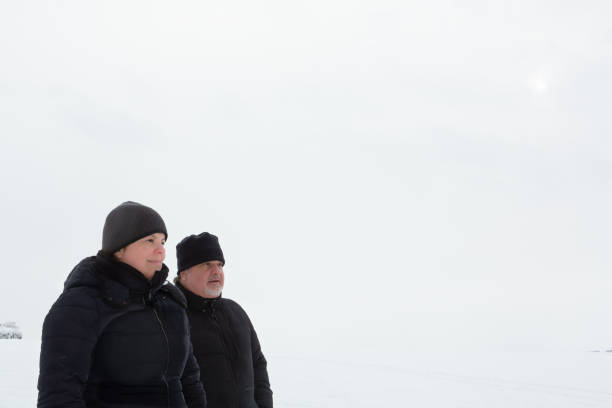 istock Couple is looking far away while they enjoy a cold winter season day 1301292078