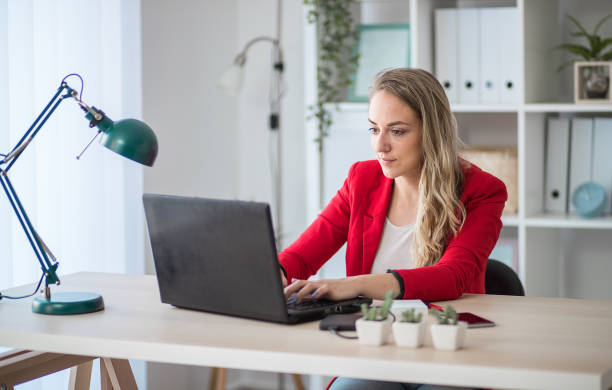 istock Young woman working in the office 1301292584