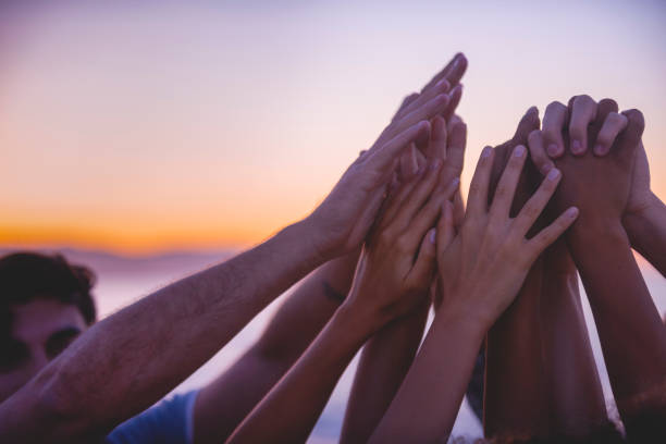 istock Group of people holding hands and doing a high five in celebration and friendship. 1301292986