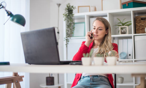istock Busy woman working, talking on the smartphone 1301293806