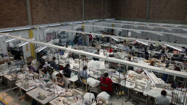 Latin american group of people working at a textile factory in their different stations