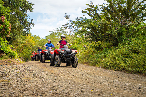 Group of latin tourists driving a 4x4 bike in Costa Rica