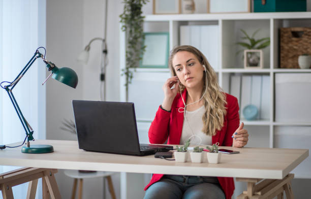 istock Woman listening music at work 1301294991