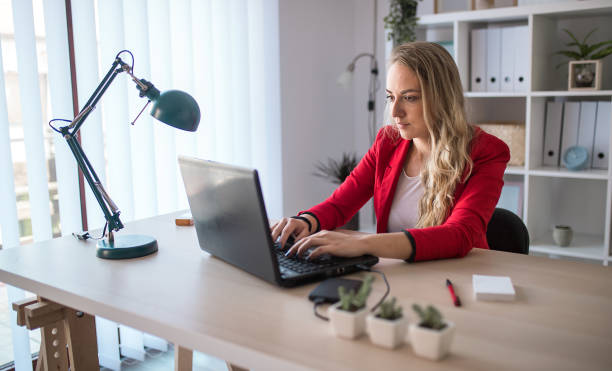 istock Young beautiful businesswoman working on her laptop computer 1301295307