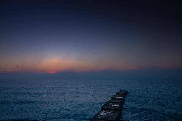 Sunrise over the sea - pier, sea, storm clouds