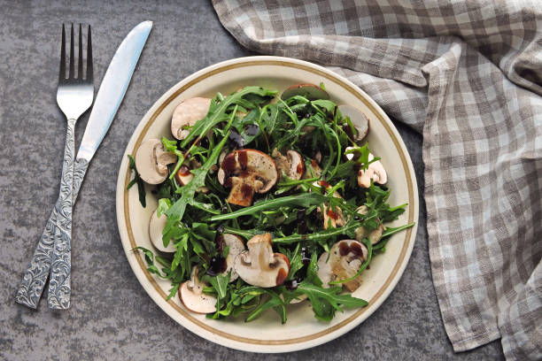 Healthy salad with arugula and raw champignons. stock photo