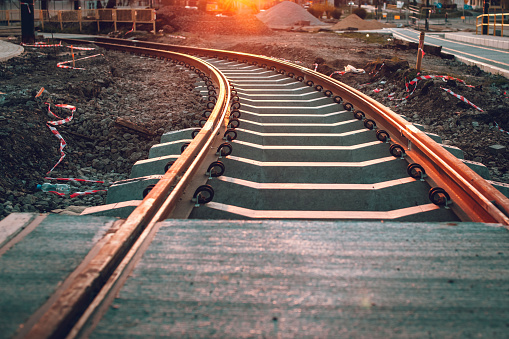 Tram tracks leading towards the setting sun