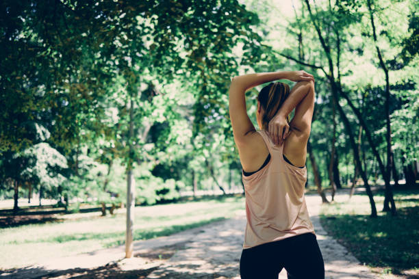 istock Rear view of fit runner doing warmup exercises in nature. 1301300250