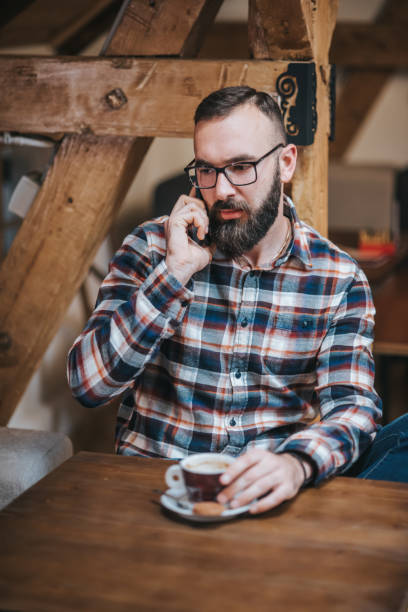 istock Young man sitting in a cafe stock photo 1301300902