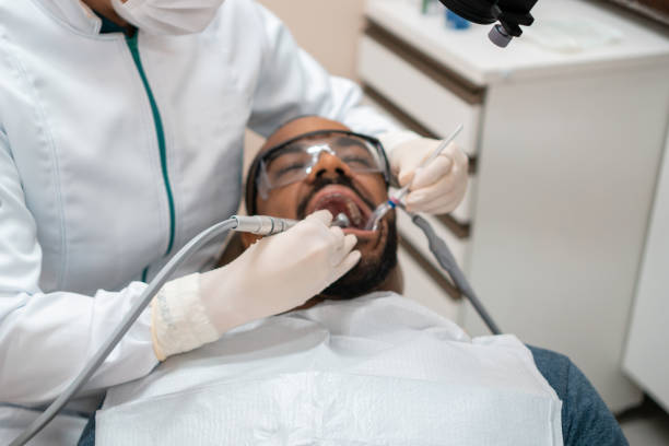 istock Dentist removing caries from patient 1301303242