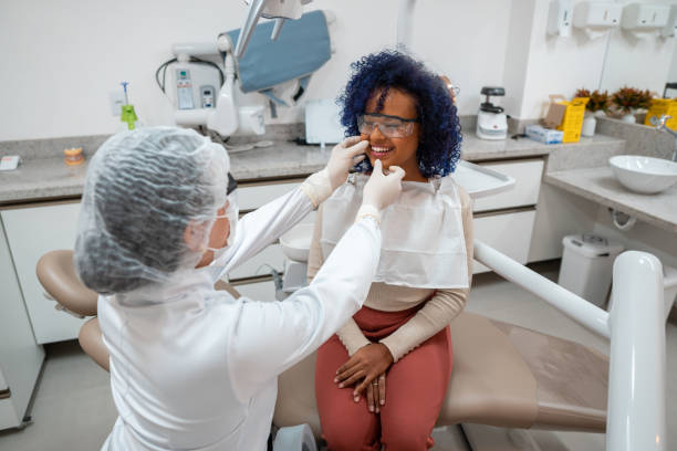 istock Smiling young woman during dental exam 1301303274