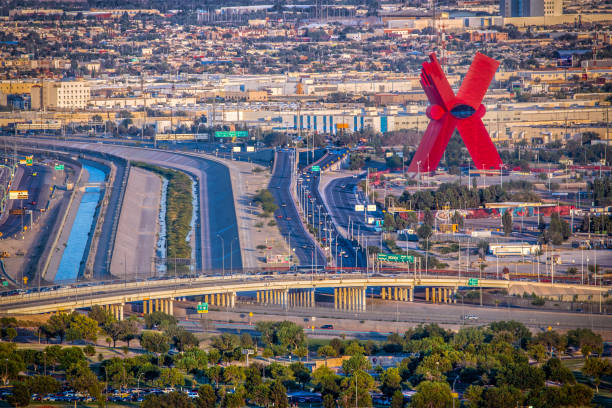 The X El Paso, Texas / USA - June 18, 2016: Evening at US-Mexican border bridge and La Equis, or The X, a 197 foot tall red monument in Juárez, Mexico with a glass viewing area in the middle. ciudad juarez photos stock pictures, royalty-free photos & images