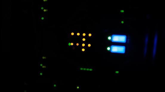Blurred background server bokeh blink green and red led lamp. Display panel of the computer equipment lamps, the serer room in the night.