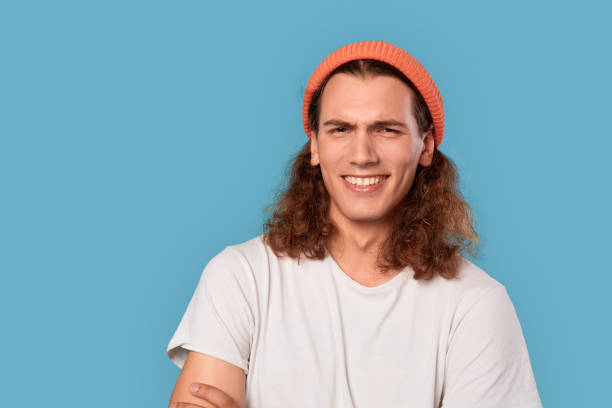 istock Young adult man smiling and making grimace 1301308779
