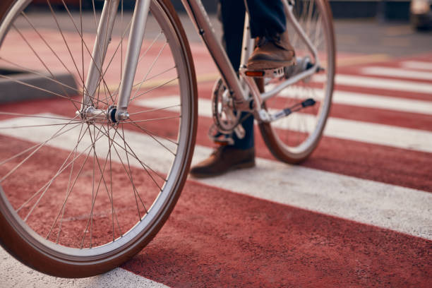 istock Crop man riding bicycle on street crosswalk 1301309217