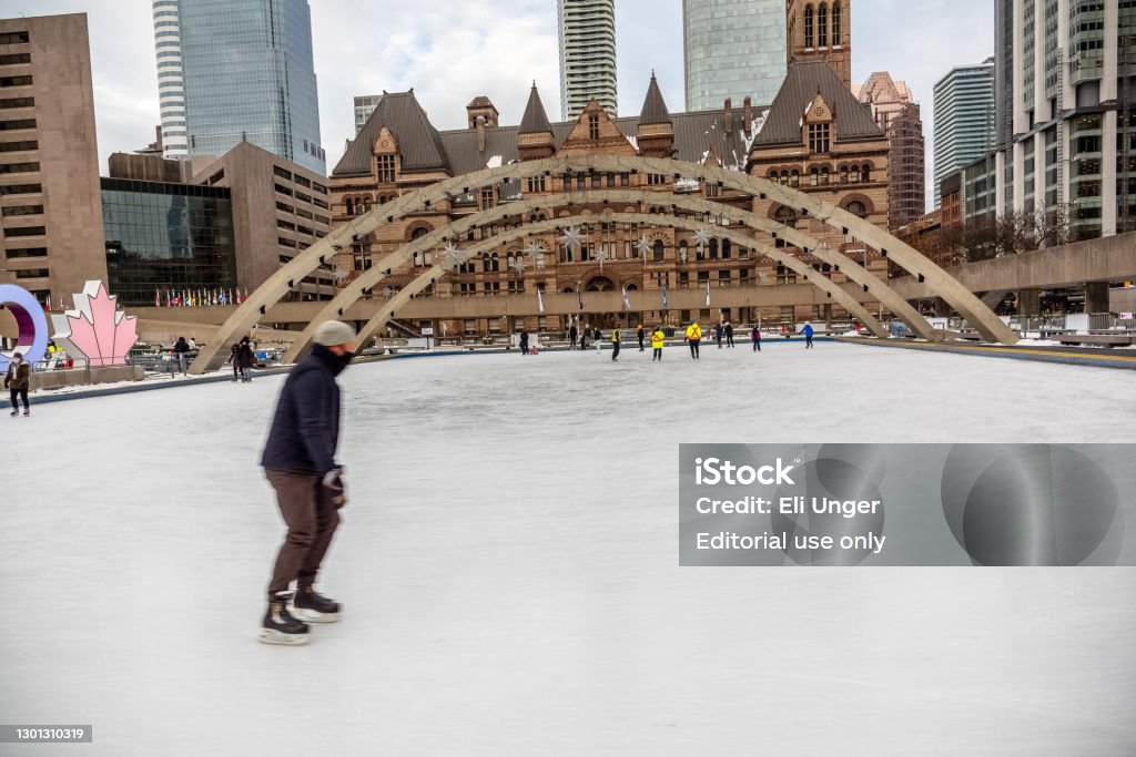 Skating at Nathan Phillips Square January 29 2021- people skating at Nathan Phillips Square in the winter. Toronto Stock Photo