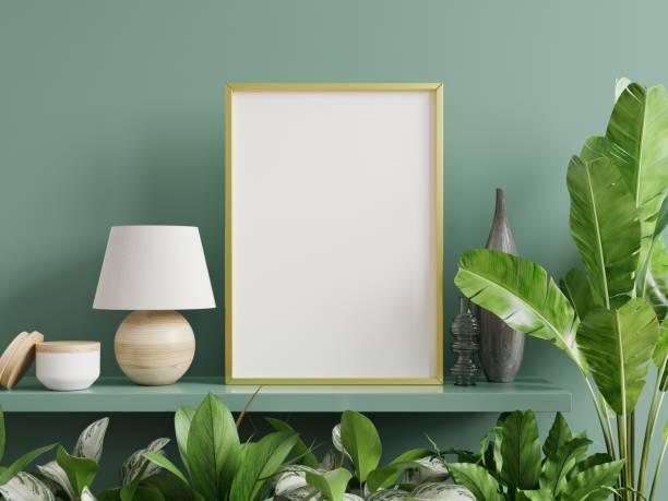istock Mockup photo frame on the green shelf with beautiful plants. 1301310579