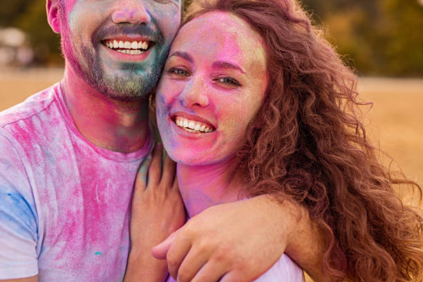 istock Crop man hugging girlfriend during paint party 1301314295