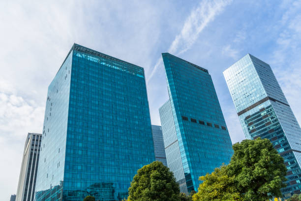 istock modern office building with green trees 1301316479