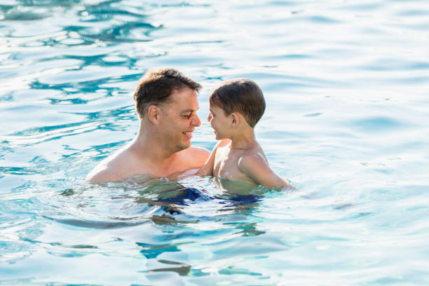 istock Father and son in swimming pool 1301317396