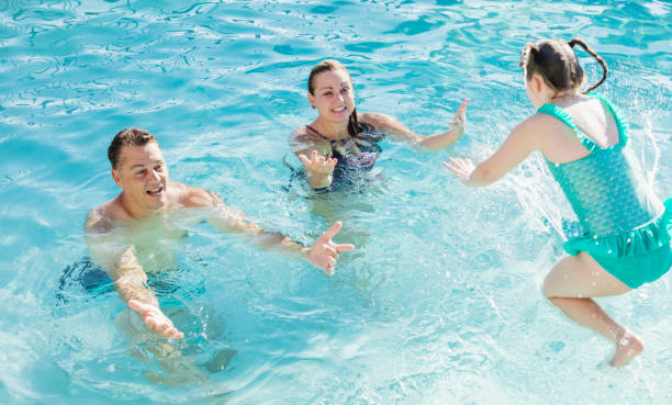 istock Girl with down syndrome, jumping into pool 1301317535