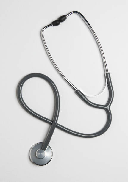 Stethoscope isolated on white background. Sterile doctors office desk. Medical accessories on a white table background with copy space around products. Photo taken from above.