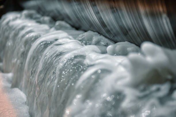 Waste water washing from metal, Metal drum of magnetic separator, bubbling and foaming water.