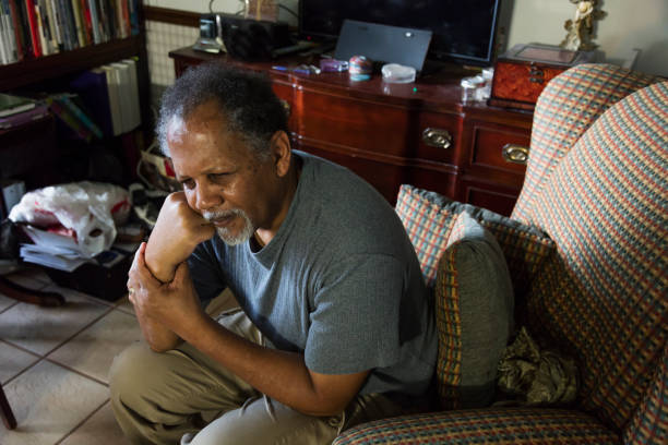 istock Lonely senior man sitting at home 1301318394