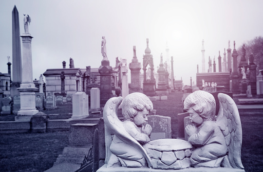 Two angels praying at the cemetery