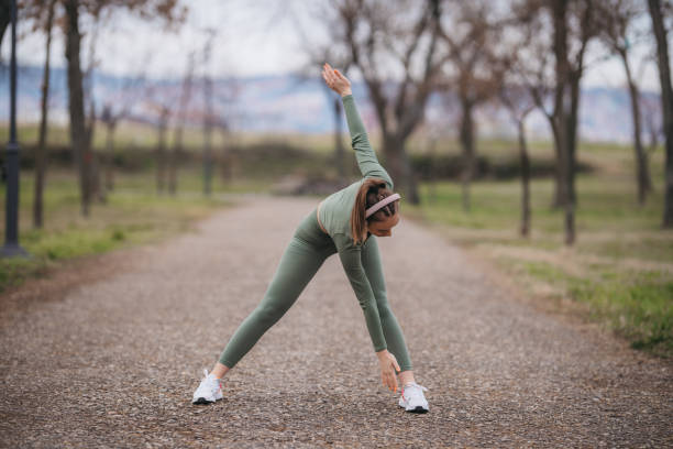 istock Young fit woman stretching before jogging in park 1301322093