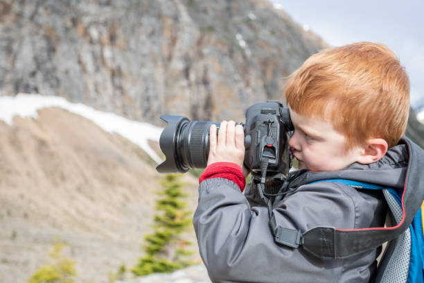 istock Young Boy Avalanche Watching and Taking Pictures at Mount Edith Cavell, Alberta, Canada 1301324808