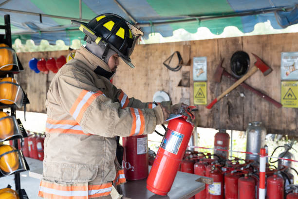 fireman check Carbon Dioxide Asian fireman check Carbon Dioxide in fire extinguisher System ready In the event of a fire at fire station. Preparation for work Concept. fire inspection stock pictures, royalty-free photos & images