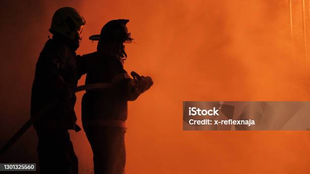 Firefighter Spray Water Fighting Stock Photo - Download Image Now - Firefighter, Fire Station, Fire Engine