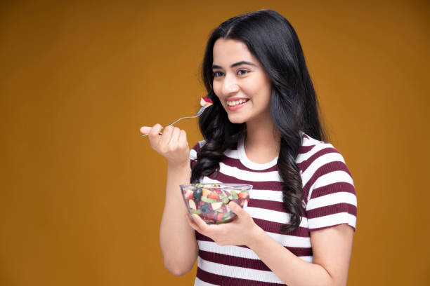 Portrait of young woman, stock photo Indian, Modern, Lifestyle, background, Eating apples stock pictures, royalty-free photos & images