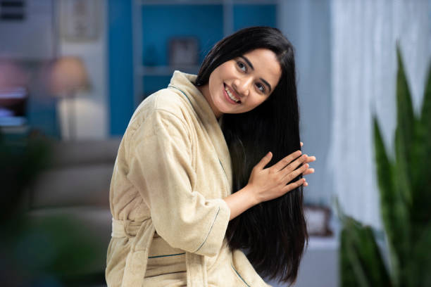 young Woman applying oil in hair care concept. stock photo young women, happy, applying , oil, hair care, India , Indian ethnicity, black hair stock pictures, royalty-free photos & images