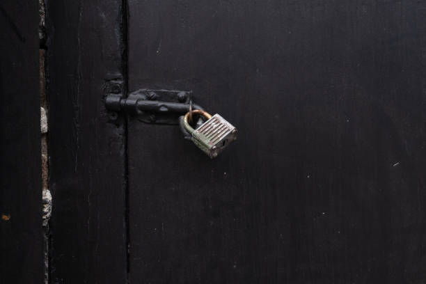 Padlock on a black wooden door