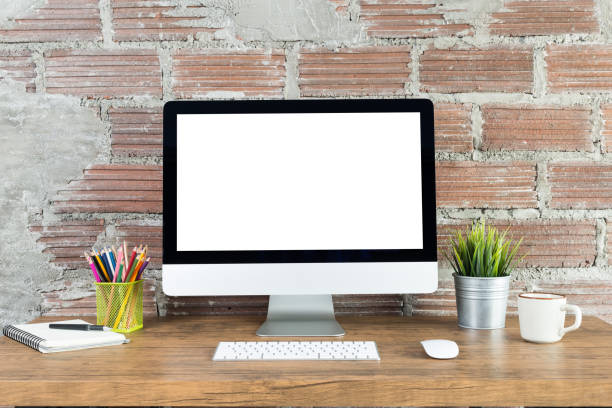 istock workspace with computer with blank white screen, and office supplies on a wooden desk 1301333438