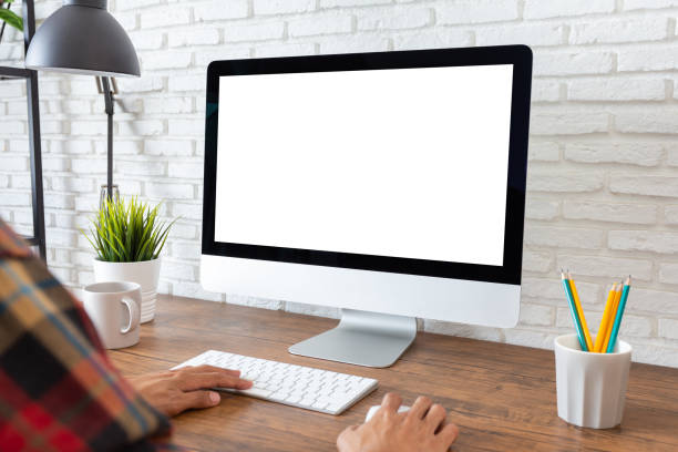 istock Mockup, man working empty screen computer on wood desk in home 1301333444