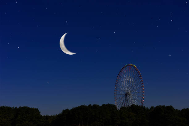 istock Crescent moon rising over the Ferris Wheel 1301336905