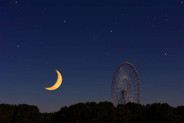 istock Crescent moon rising over the Ferris Wheel 1301336925