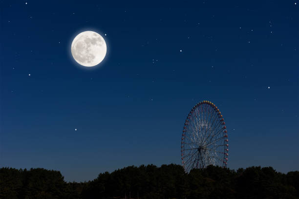 istock Full moon rising over the Ferris Wheel 1301336930