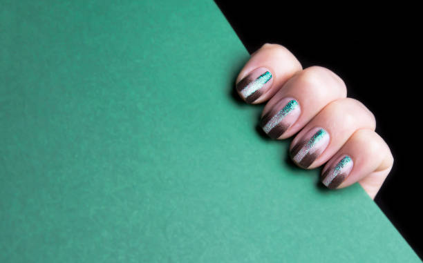 istock Short female manicure. Manicure with a black gradient and a shiny stripe. 1301338725