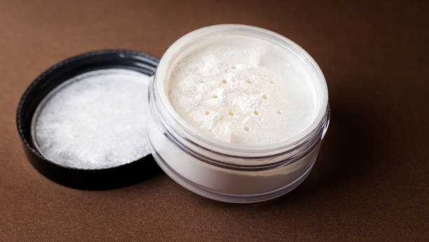 istock Skin matting powder on a brown background. White powder. 1301338748
